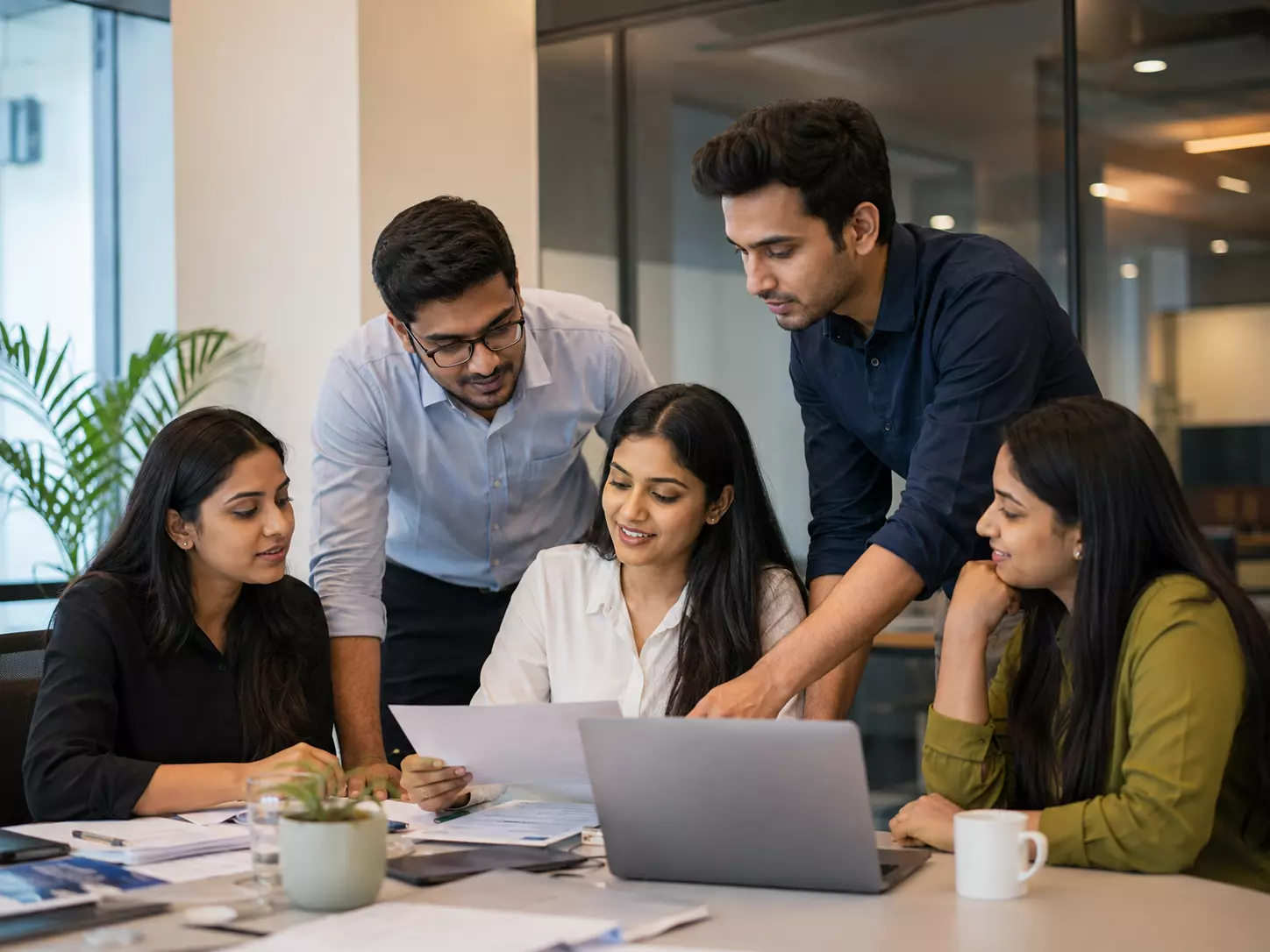 Indian customer service professional speaking on a phone in an office