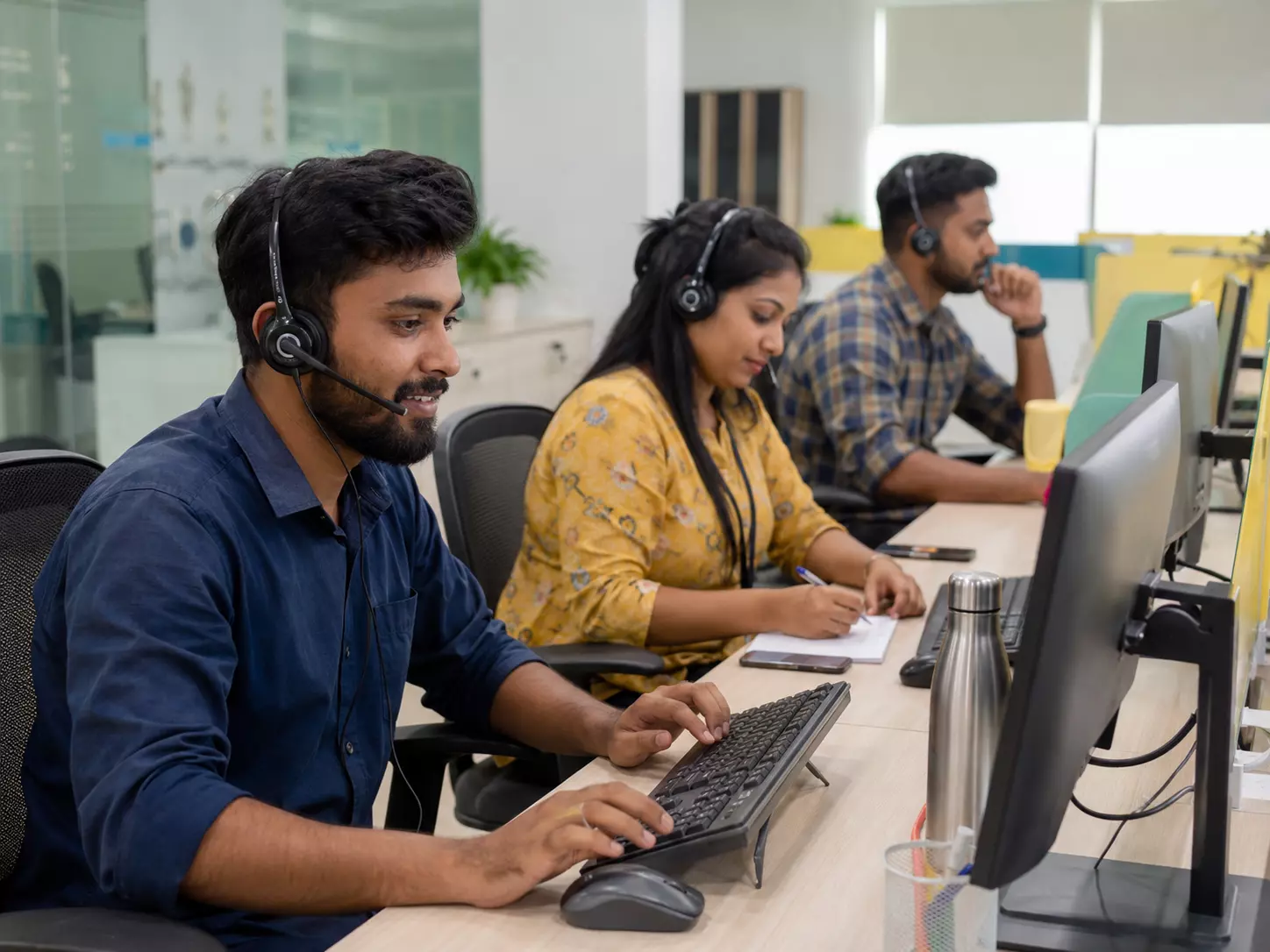 Indian customer support team working in a modern office